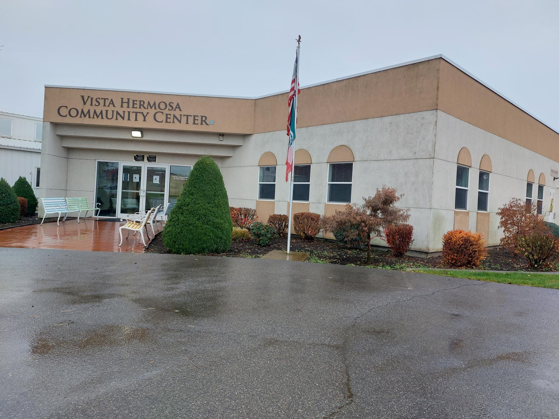 A beige building with a flag outside